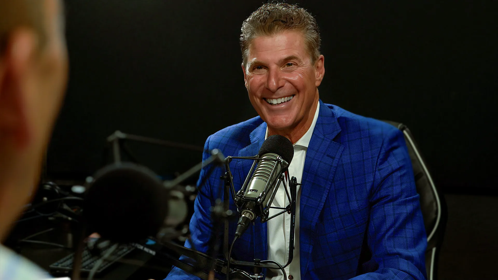 Alfie Tounjian at the studio microphone recording the Saving the Investor radio show and podcast
