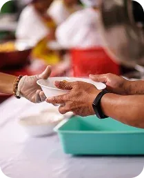 Volunteers serving a meal at a community event